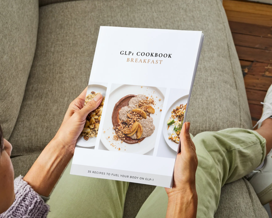 GLP-1 Breakfast Cookbook open on kitchen counter next to morning prep items