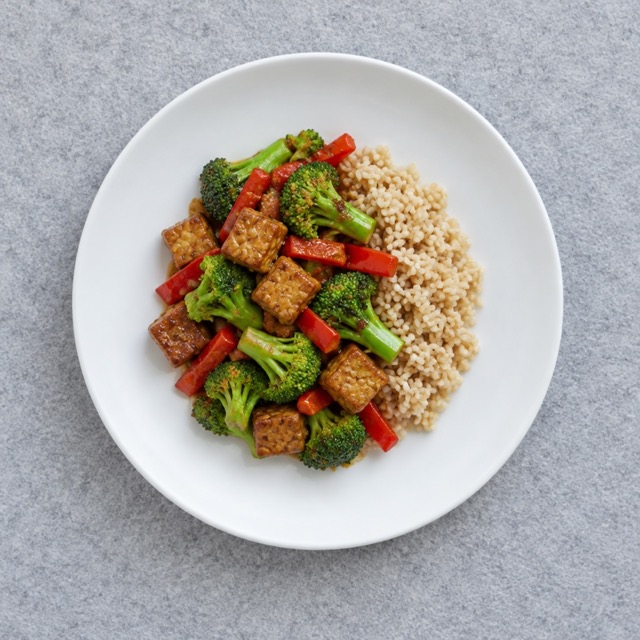 Lentil and quinoa salad on a white plate, a plant-based high protein vegan lunch